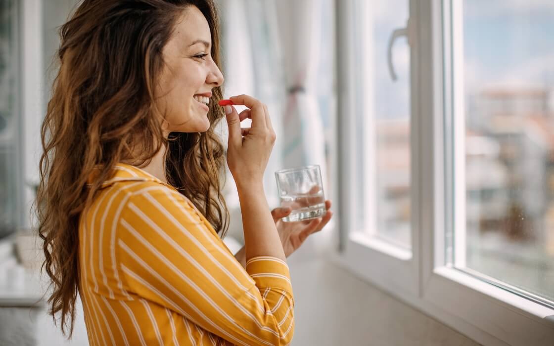 Woman taking a supplement